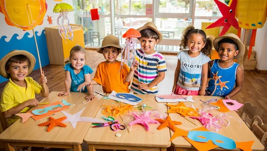 Preschoolers making ocean crafts for preschoolers with starfish and jellyfish, perfect for summer and beach theme activities.