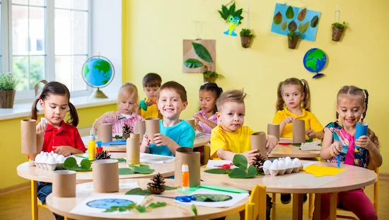 Children creating simple & sustainable earth day craft preschool projects with recycled and natural materials.

