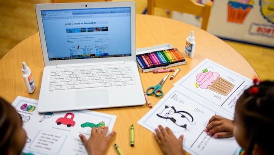 More learning opportunities with letter c crafts for preschool—children using laptop for printables and video tutorials, with cat, car, cupcake, and caterpillar worksheets.