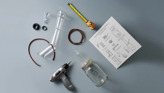 DIY bong kit for beginners, showing glass parts, mason jar, drill, tubing, and step-by-step instructions on a blue background.