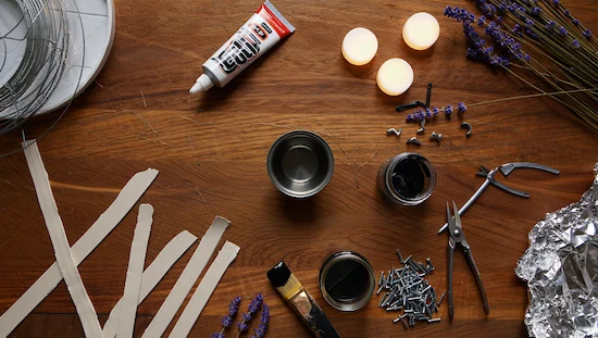 Easy DIY cauldron materials including wire, glue, paint, pliers, candles, and more for crafting a creative cauldron project at home.