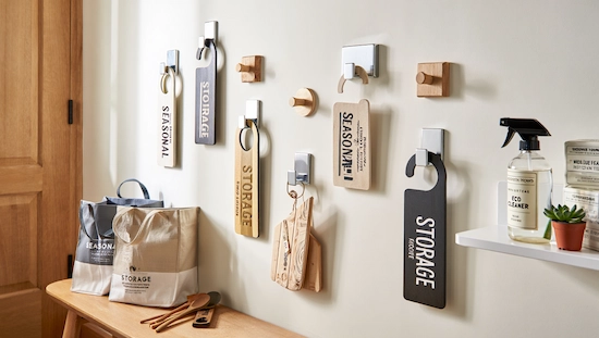 Organized diy door hanger storage and display on wall hooks, with labeled totes, eco cleaner, and shelf, showing pro care and display tips.

